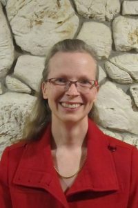 Picture of Elke Haggerty. Elke's optimistic and smiles a lot, and she has a big smile in this picture.
