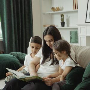 Mom reading with two kids on a couch
