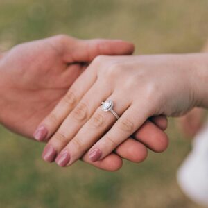 A couple's hands with engagement ring